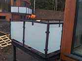 Balkon met glazen balustrade. Ondersteunende constructie van verzinkte, gepoedercoate stalen profielen